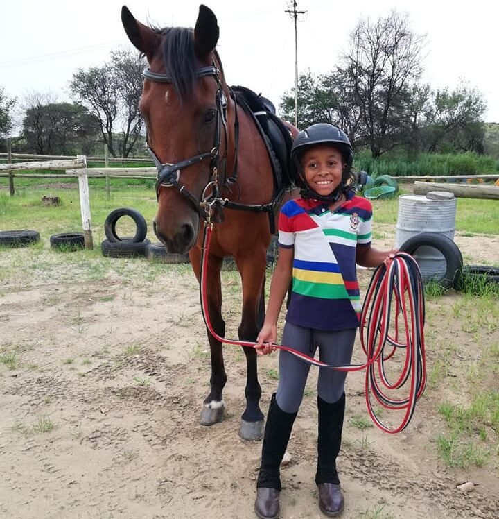 Young rider having a lunge lesson